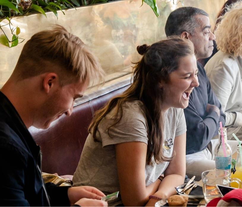 Amsterdam coffee shop interior friends laughing relaxed social atmosphere