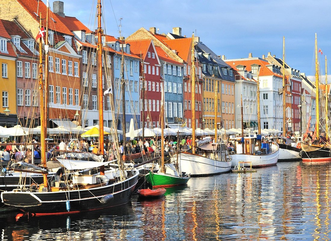 Bike tour Copenhagen Denmark Nyhavn colourful buildings canal waterfront