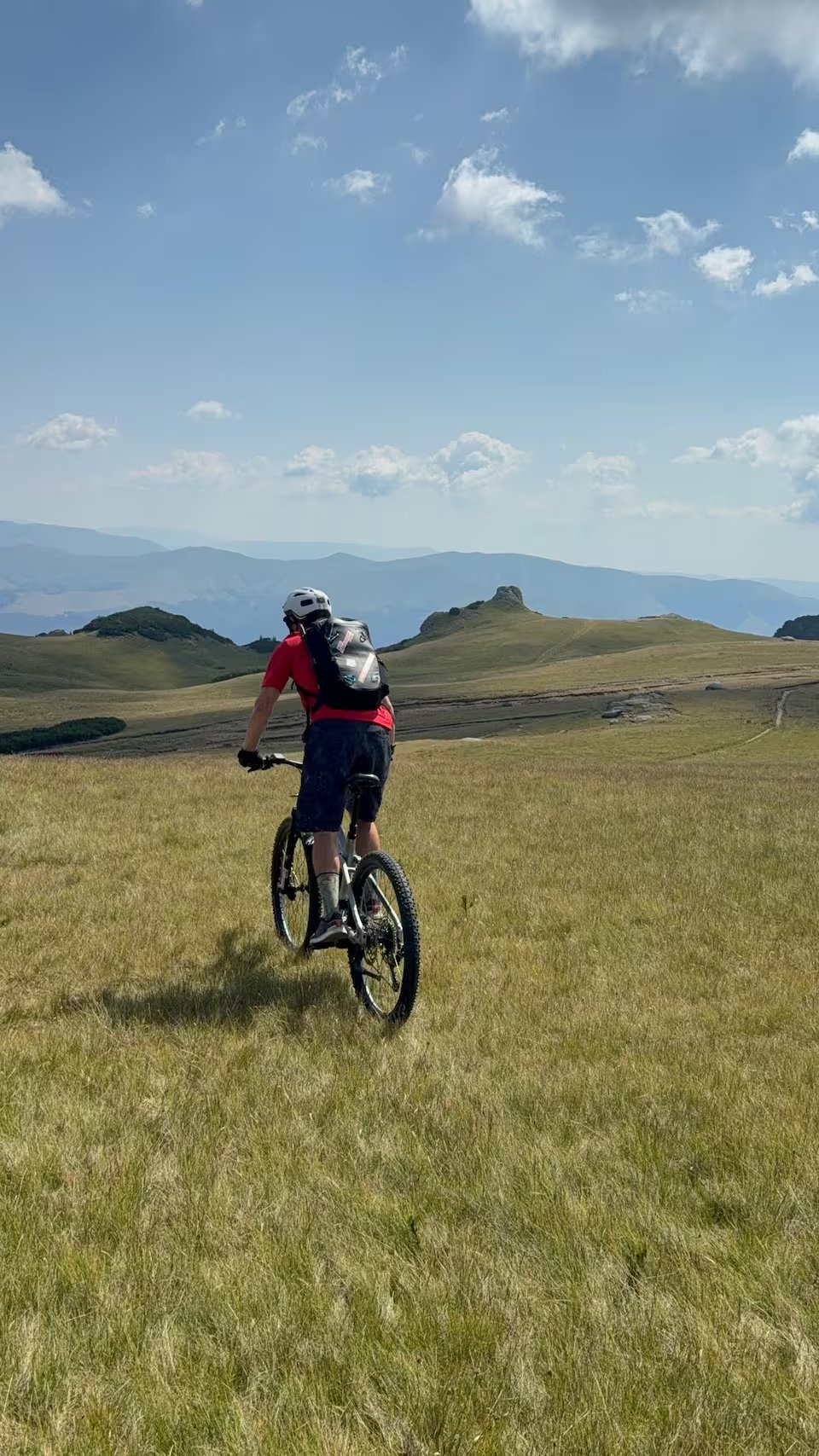 E-bike riding Carpathian high meadows Romania mountain panorama