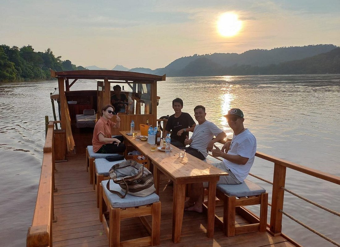Mekong River sunset cruise wooden boat Luang Prabang Laos hot pot dinner