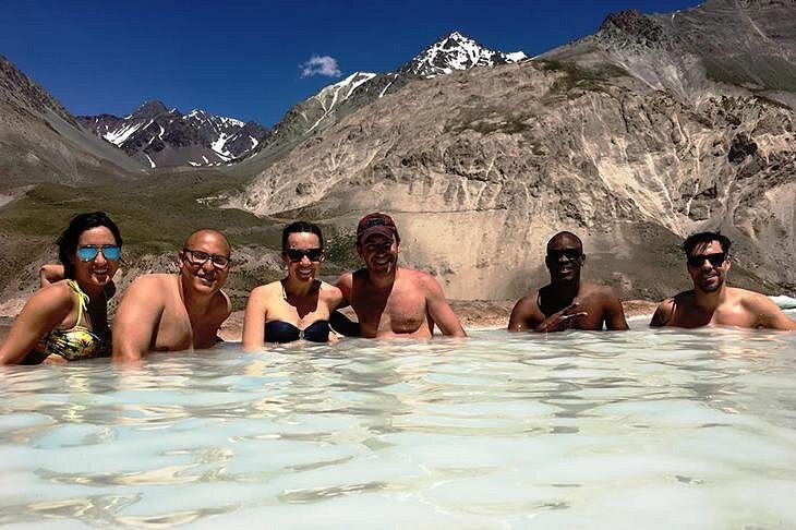 Natural hot springs Chile Andes mountains friends bathing geothermal